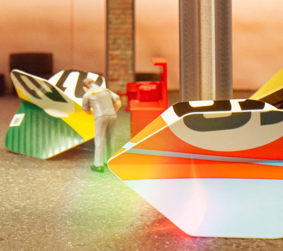 Miniature model working on the Chicane orange and green dart flights