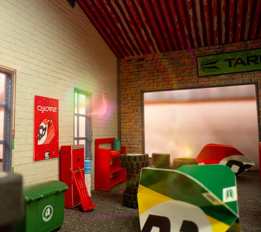 Close-up of the green Chicane dart flight in a miniature car garage