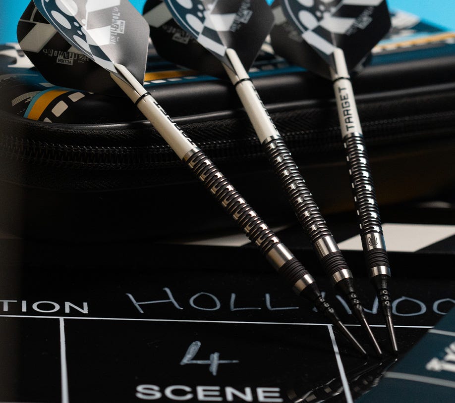 A collection of Hollywood Action soft tip darts leaning on the Chris Dobey Takoma Wallet.