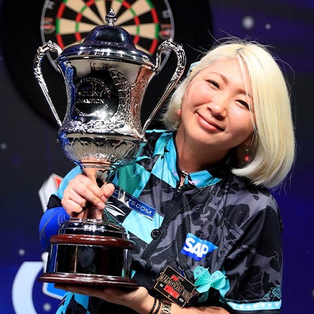 Mikuru Suzuki holding a darts trophy