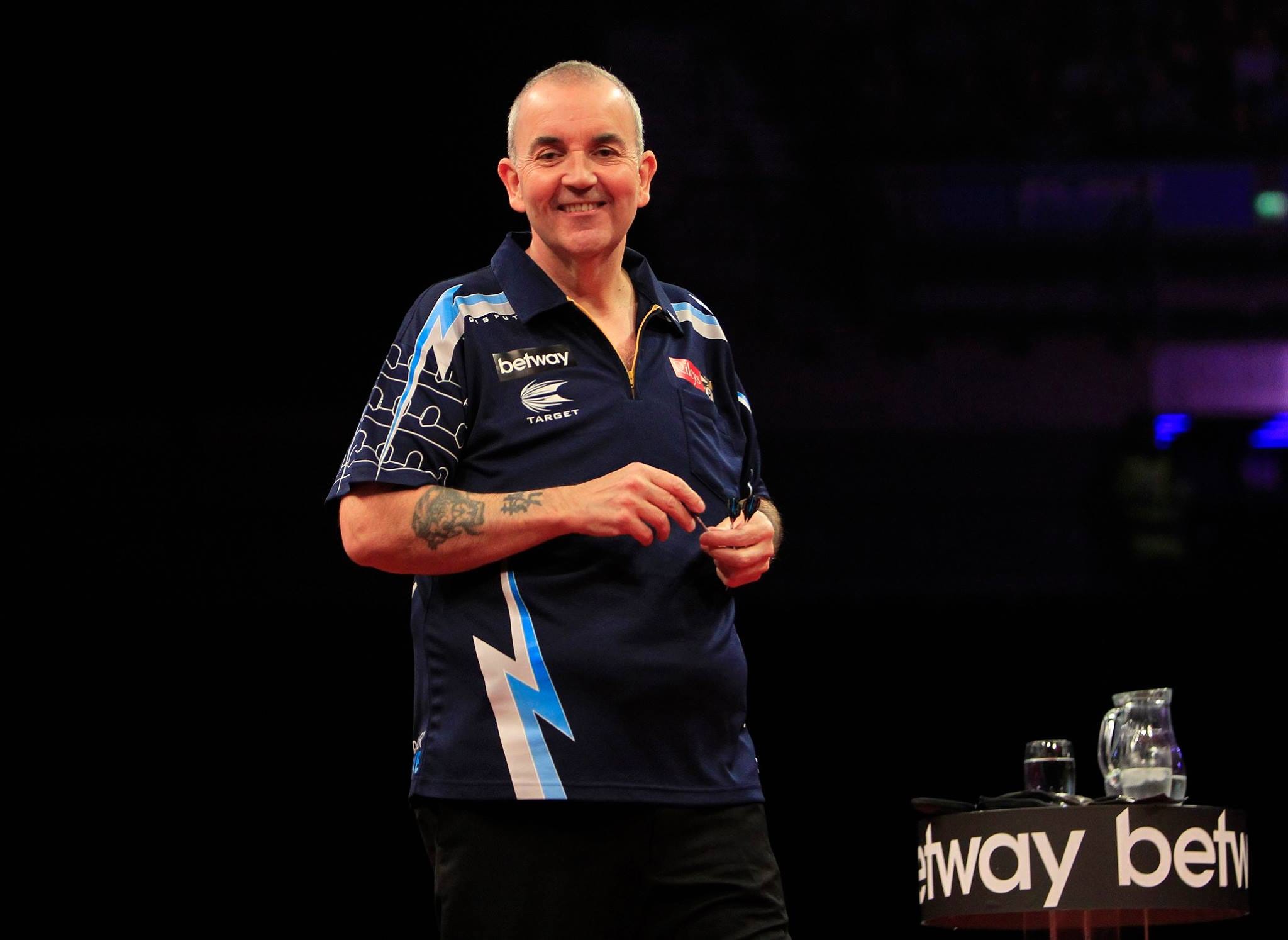 Phil Taylor smiling towards the crowd at the World Matchplay