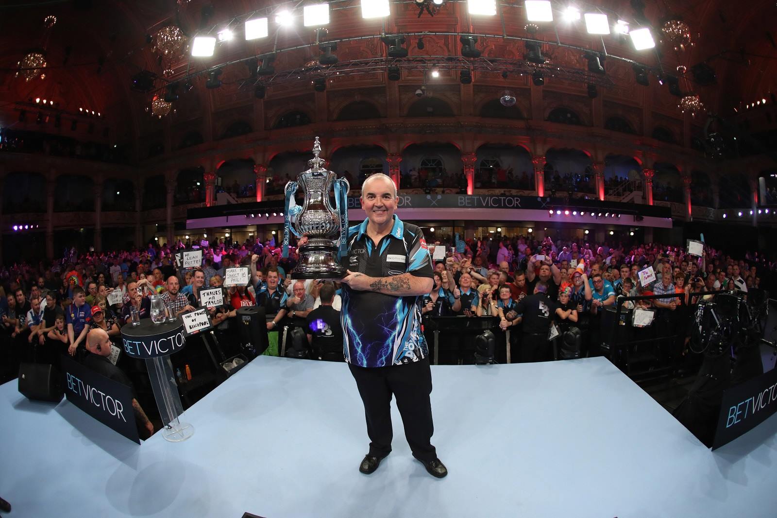 Phil 'The Power' Taylor celebrating winning the World Matchplay with the trophy