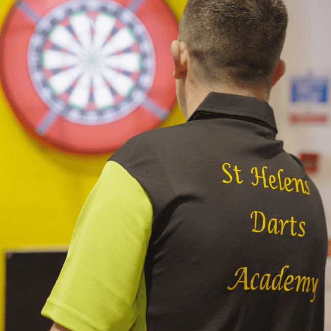 St Helens Youth Darts Academy player throwing a dart at a dartboard