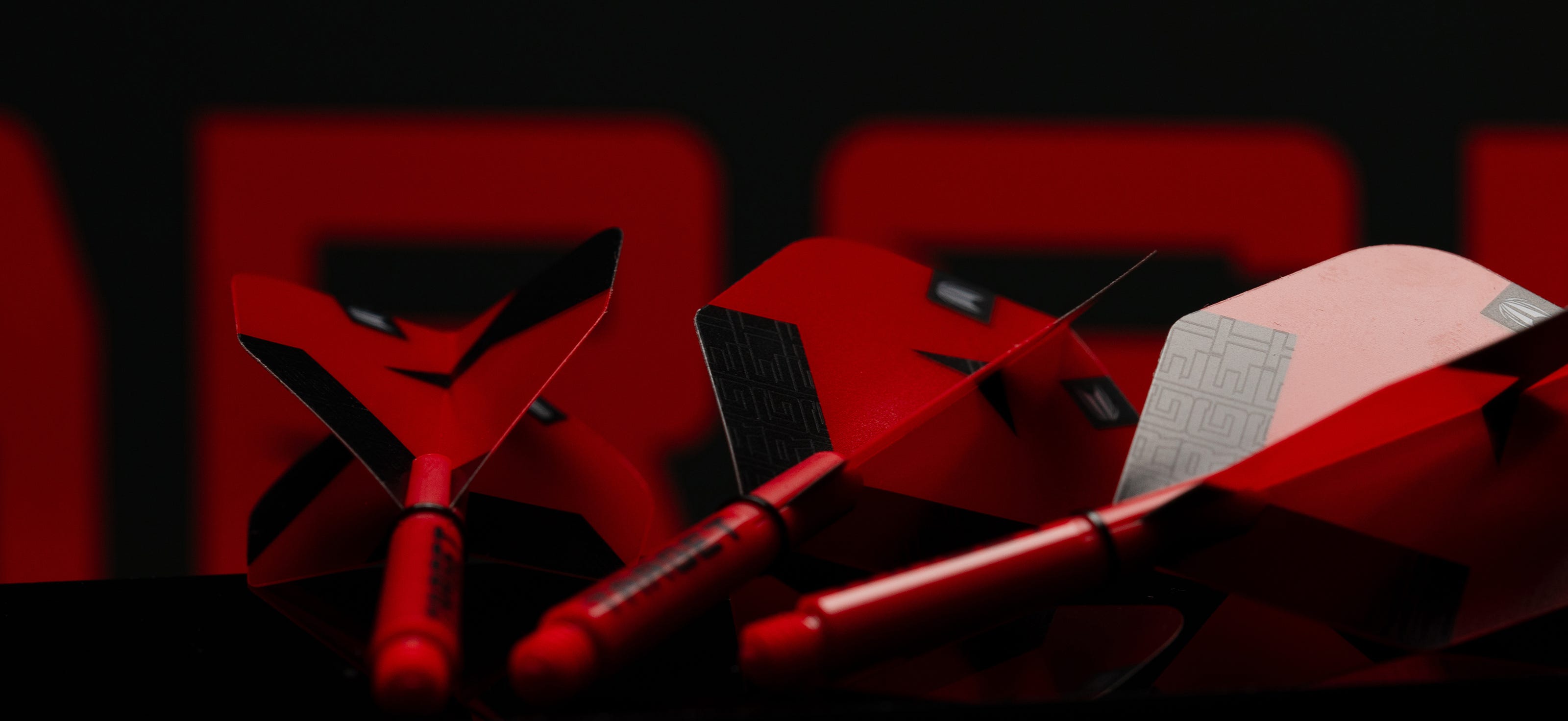 Close-up of the Pro Grip Tag dart shafts in red.