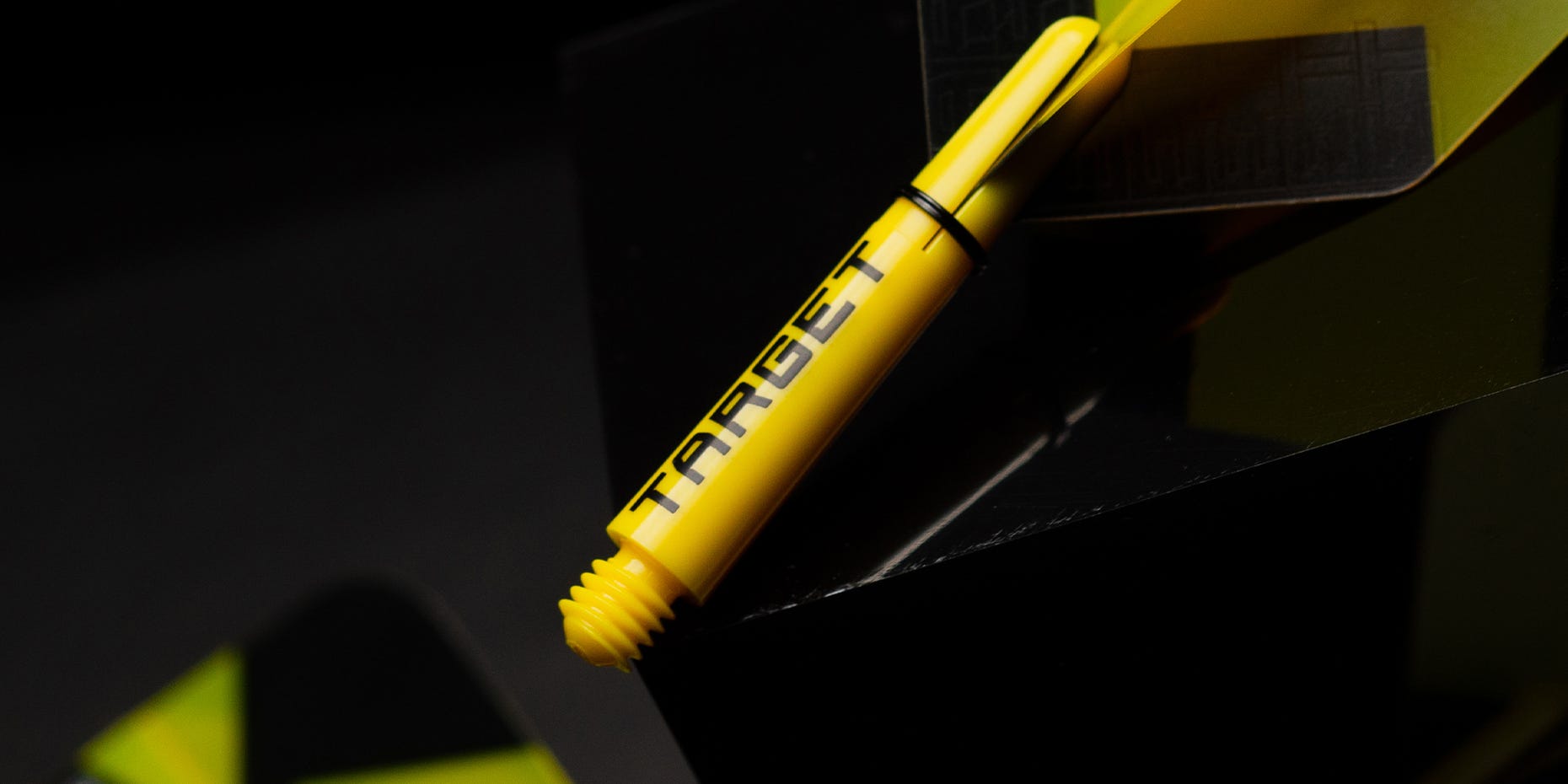 A close-up of the TAG Pro Grip dart shaft in yellow.