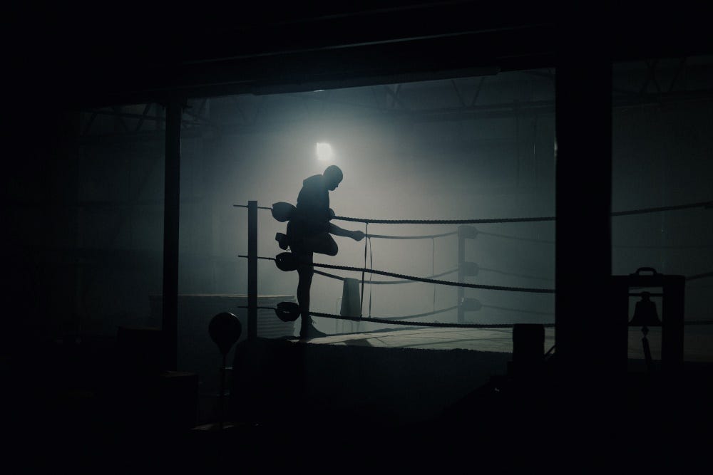 Sillouhette of Johnny Fisher Climibing into boxing ring