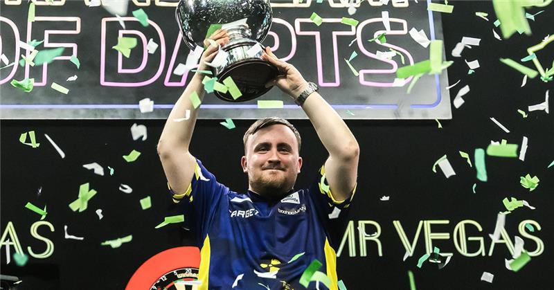 Luke Littler holds Grand Slam of Darts trophy aloft