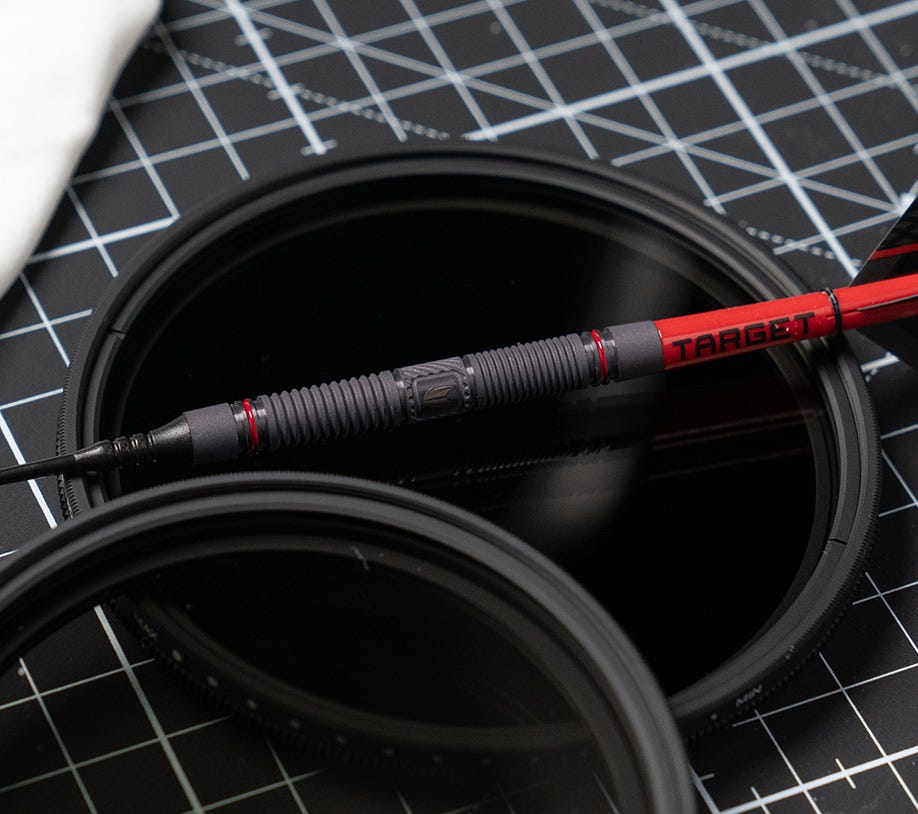 Scope dart balanced on DSLR camera lens